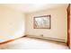 Bright bedroom featuring neutral walls, trim, and carpet with a single window providing natural light at 14080 Crabapple Rd, Golden, CO 80401