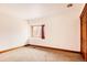 Bright bedroom featuring neutral walls, trim, and carpet with a single window providing natural light at 14080 Crabapple Rd, Golden, CO 80401