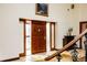 Foyer with tile floor, beautiful wood front door, and open floorplan at 14080 Crabapple Rd, Golden, CO 80401