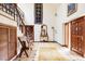 Spacious foyer boasts staircase with striking millwork and tile floor at 14080 Crabapple Rd, Golden, CO 80401