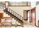 Grand foyer with staircase, custom iron railing, and tile flooring at 14080 Crabapple Rd, Golden, CO 80401