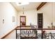Upstairs hallway featuring decorative wrought iron railing, architectural beam, and framed painting for a vintage design at 14080 Crabapple Rd, Golden, CO 80401