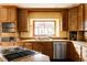 Traditional kitchen featuring wooden cabinetry, stainless steel appliances, and granite counters at 14080 Crabapple Rd, Golden, CO 80401