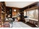 Cozy library featuring custom built-in shelving and large window seat at 14080 Crabapple Rd, Golden, CO 80401