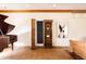 Grand piano in a spacious room with a bookcase, hardwood floors, and natural light at 14080 Crabapple Rd, Golden, CO 80401