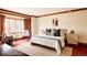 Comfortable main bedroom with large window, red carpet, and cozy sitting area, providing a tranquil retreat at 14080 Crabapple Rd, Golden, CO 80401