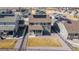 Aerial view of the property, showcasing the fenced backyard and neighborhood with solar panels on nearby houses at 8240 S White Crow St, Aurora, CO 80016