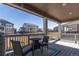 Inviting back deck with table and chairs, perfect for outdoor relaxation and enjoying neighborhood views at 8240 S White Crow St, Aurora, CO 80016
