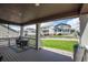 Relaxing back porch with outdoor seating, offering views of the well-maintained lawn and neighboring homes at 8240 S White Crow St, Aurora, CO 80016
