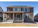 Exterior of home showcasing a covered patio and backyard with solar panels on the roof at 8240 S White Crow St, Aurora, CO 80016