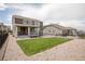 Expansive backyard with a covered porch, a well-maintained lawn, and tasteful stone landscaping at 8240 S White Crow St, Aurora, CO 80016