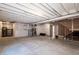 Unfinished basement featuring a concrete floor and exposed ceiling at 8240 S White Crow St, Aurora, CO 80016