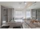 Bright bathroom featuring a glass-enclosed shower, soaking tub, and granite countertops at 8240 S White Crow St, Aurora, CO 80016