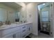 Bathroom with white vanity, double sinks, a toilet, and a view into the shower/toilet room at 8240 S White Crow St, Aurora, CO 80016