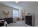 Bedroom includes a dresser, a teddy bear, a window, a blind, and a door leading to a bathroom at 8240 S White Crow St, Aurora, CO 80016