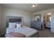 Bedroom featuring a decorative bed frame, dresser, and adjoining bathroom at 8240 S White Crow St, Aurora, CO 80016