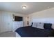 Bedroom with a white bed frame and dresser, dark bedding, and a TV at 8240 S White Crow St, Aurora, CO 80016