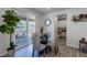A dining area features a glass table with gray upholstered chairs, and a large sliding glass door to the outdoor patio at 8240 S White Crow St, Aurora, CO 80016