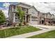 Beautiful two-story home boasting stone accents, a covered porch, and a green lawn at 8240 S White Crow St, Aurora, CO 80016