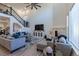 Bright living room with soaring ceilings, fireplace, and a staircase with metal railing at 8240 S White Crow St, Aurora, CO 80016