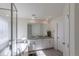 Main bathroom features double sinks, soaking tub, and glass enclosed shower with bright natural light at 8240 S White Crow St, Aurora, CO 80016