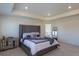 Spacious main bedroom with a tray ceiling, recessed lighting, and plush carpet at 8240 S White Crow St, Aurora, CO 80016