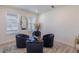 Sitting room features a round coffee table with four dark velvet chairs, and two windows allowing natural light to enter at 8240 S White Crow St, Aurora, CO 80016