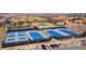 Aerial view of tennis courts and pool area within the community; cars parked nearby at 8240 S White Crow St, Aurora, CO 80016