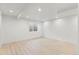 Finished basement with laminate flooring, recessed lighting and a window at 1065 Cobblestone Dr, Highlands Ranch, CO 80126