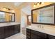Bathroom with dual vanity sinks, marble countertops, and adjacent shower at 1065 Cobblestone Dr, Highlands Ranch, CO 80126