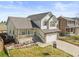 Attractive two-story home with a cozy front porch, two-car garage, and well-maintained lawn at 1065 Cobblestone Dr, Highlands Ranch, CO 80126