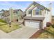Inviting two-story home with a two-car garage and a well-kept lawn and landscape at 1065 Cobblestone Dr, Highlands Ranch, CO 80126