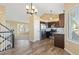 Modern kitchen with stainless steel appliances, dark wood cabinets and an adjacent living area at 1065 Cobblestone Dr, Highlands Ranch, CO 80126