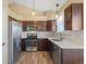 Well-lit kitchen with stainless steel appliances, wood floors, and white stone countertops at 1065 Cobblestone Dr, Highlands Ranch, CO 80126