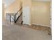 Bright living room showcasing stairs to the second floor, and multiple flooring types at 1065 Cobblestone Dr, Highlands Ranch, CO 80126