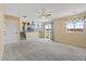 Open-concept living area with carpet, staircase, and natural light at 1065 Cobblestone Dr, Highlands Ranch, CO 80126