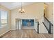 Bright living room with wood floors, staircase, and view of a fireplace at 1065 Cobblestone Dr, Highlands Ranch, CO 80126
