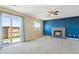 Cozy living room with fireplace, carpeted floors, and access to the outdoors at 1065 Cobblestone Dr, Highlands Ranch, CO 80126