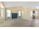 Bright living room featuring carpet floors, large windows, and adjacent kitchen at 1065 Cobblestone Dr, Highlands Ranch, CO 80126