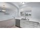 Bright kitchen features white cabinets, stainless steel dishwasher and sink with a view of the outdoors at 12711 Colorado Blvd # 1116, Thornton, CO 80241
