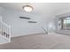 Bright living room with plush carpeting, staircase, and large windows offering plenty of natural light at 12711 Colorado Blvd # 1116, Thornton, CO 80241