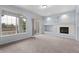 Bright living room with fireplace and access to a balcony through sliding glass doors at 12711 Colorado Blvd # 1116, Thornton, CO 80241