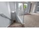 Carpeted staircase leading down, lit with modern lighting, offering a smooth transition between floors at 12711 Colorado Blvd # 1116, Thornton, CO 80241