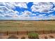 Expansive backyard view featuring natural landscapes, a wooden fence, and open space at 4220 Kestrel Dr, Broomfield, CO 80023