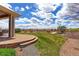 Landscaped backyard features a patio, green lawn, and decorative rock garden area at 4220 Kestrel Dr, Broomfield, CO 80023