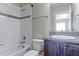 Bright bathroom features shower-tub combo, single vanity, and modern fixtures at 4220 Kestrel Dr, Broomfield, CO 80023