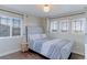Cozy bedroom features a stylish headboard, lots of natural light, and hardwood floors at 4220 Kestrel Dr, Broomfield, CO 80023