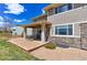 Home's exterior highlighting a covered patio, stone accents, and manicured landscaping at 4220 Kestrel Dr, Broomfield, CO 80023