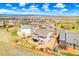 An aerial view showcases the home, a fenced yard, and a community with mountain views at 4220 Kestrel Dr, Broomfield, CO 80023