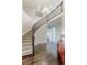 Elegant foyer showcasing a curved staircase, dark wood floors, and stylish chandelier at 4220 Kestrel Dr, Broomfield, CO 80023